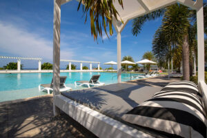 a pool with lounge chairs and umbrellas